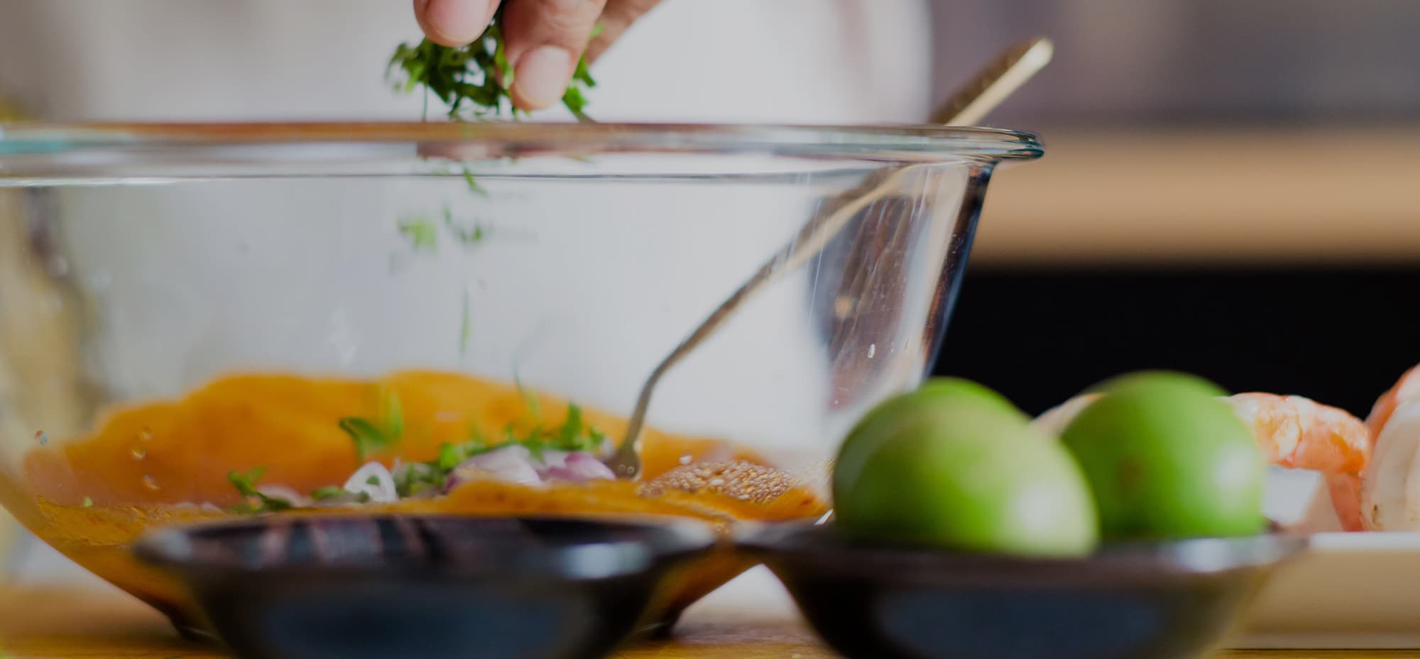 Image of a person adding fresh herbs to a bowl